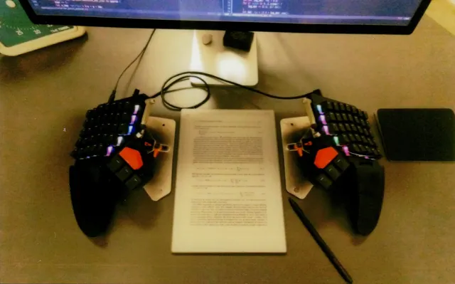 Splitted keyboard with reMarkable paper pro in portrait mode (it is a scan of a physical Instax Wide Evo print). Splitted keyboard with reMarkable paper pro in portrait mode (a scan of a physical Instax Wide Evo print).